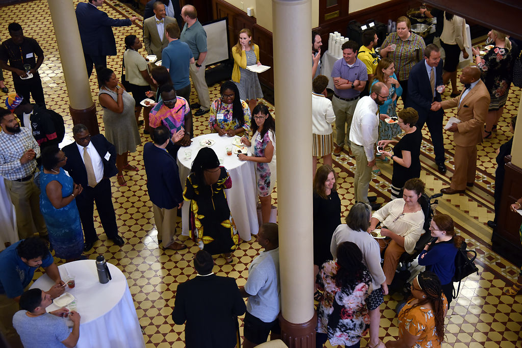 Friends, family and faculty mingle before a farewell reception